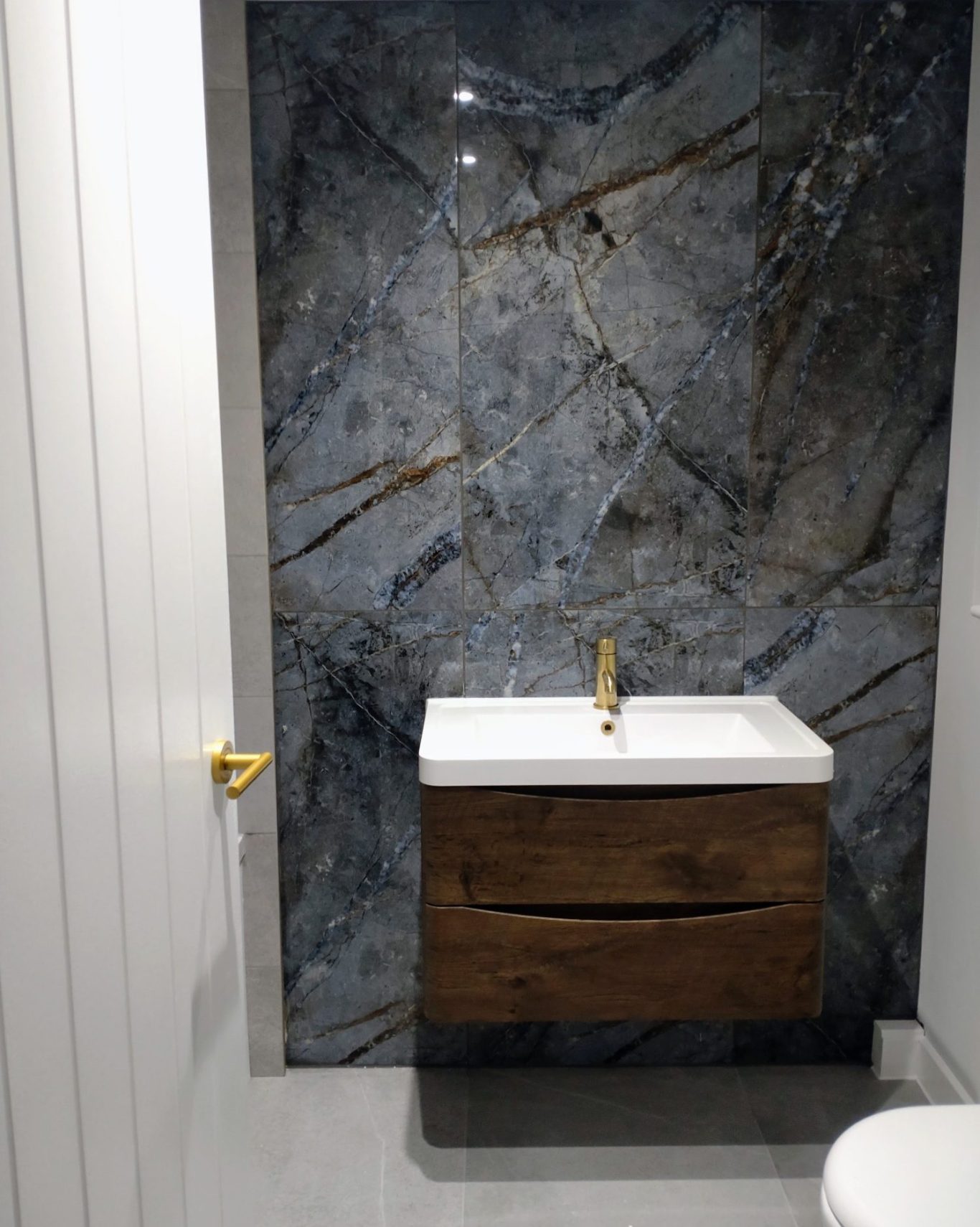 Bathroom renovation High end bathroom renovation featuring a floating vanity unit and dark marble tile.